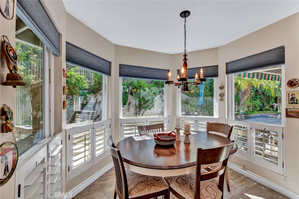 7214 East Wrangler Circle Orange, CA 92869 - Photo 24 of 69 a dining room with furniture wooden floor a chandelier and a rug