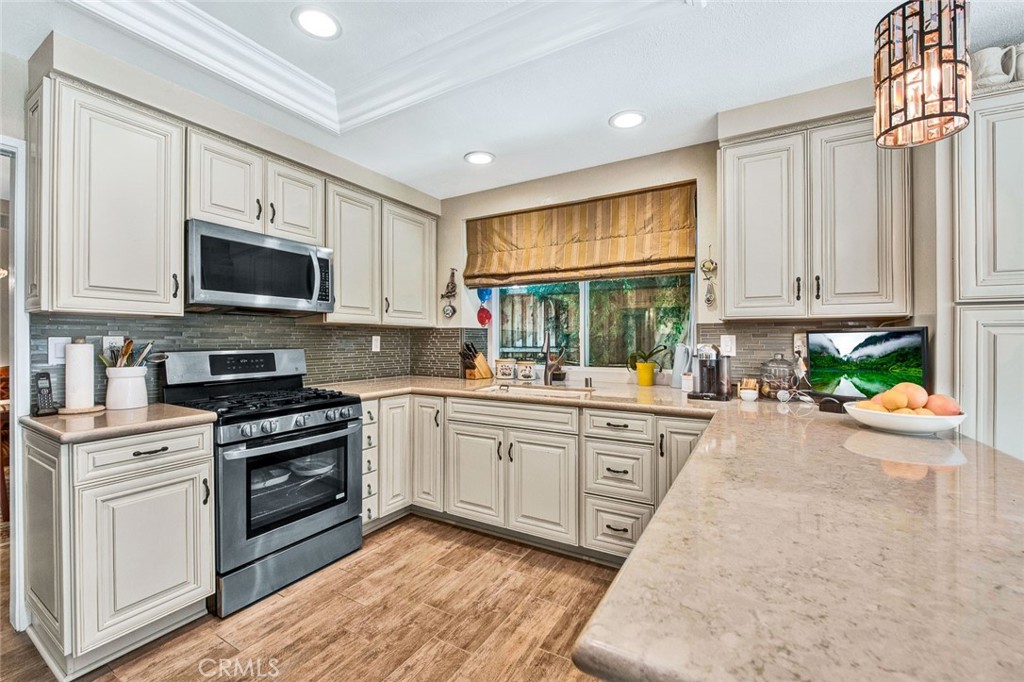7214 East Wrangler Circle Orange, CA 92869 - Photo 27 of 69 a kitchen with a stove a sink and a microwave