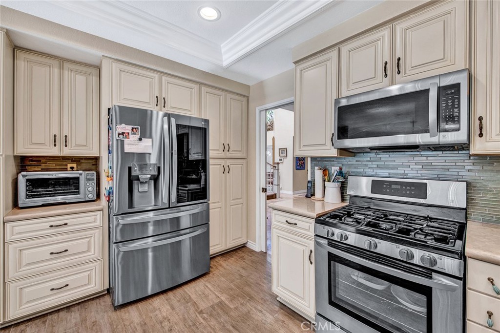 7214 East Wrangler Circle Orange, CA 92869 - Photo 29 of 69 a kitchen with cabinets stainless steel appliances and wooden floor