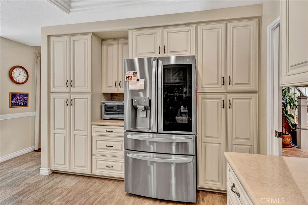 7214 East Wrangler Circle Orange, CA 92869 - Photo 31 of 69 a kitchen with stainless steel appliances a refrigerator and cabinets