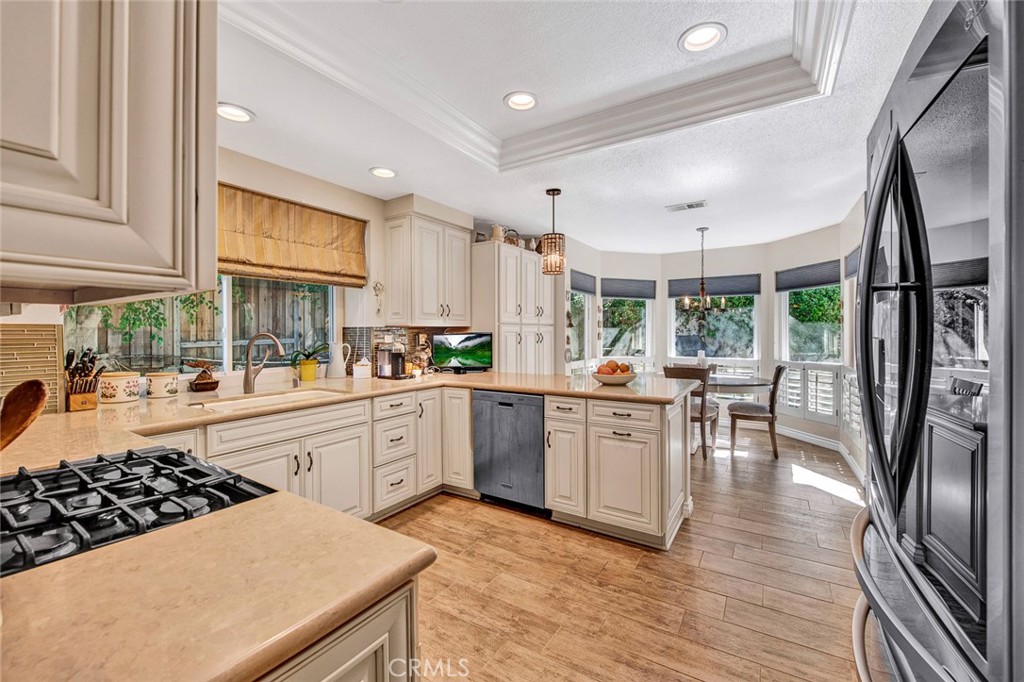 7214 East Wrangler Circle Orange, CA 92869 - Photo 33 of 69 a kitchen with counter top space a sink appliances and cabinets