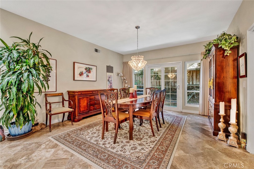 7214 East Wrangler Circle Orange, CA 92869 - Photo 37 of 69 a dining room with furniture a rug and potted plants