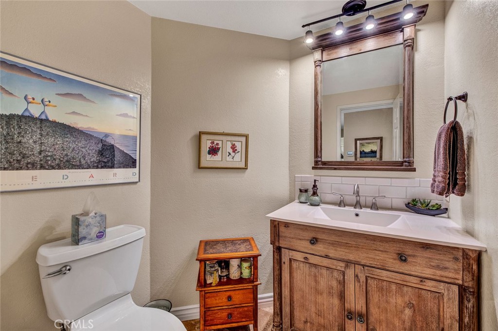 7214 East Wrangler Circle Orange, CA 92869 - Photo 39 of 69 a bathroom with a toilet sink and mirror