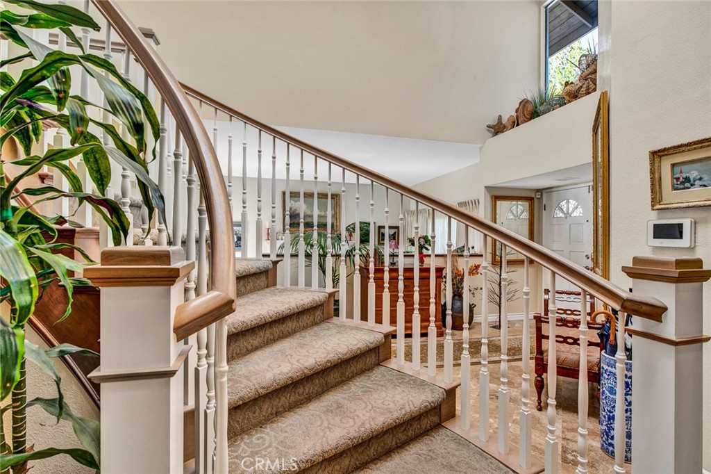 7214 East Wrangler Circle Orange, CA 92869 - Photo 40 of 69 a view of staircase with lots of frames on wall and a potted plant
