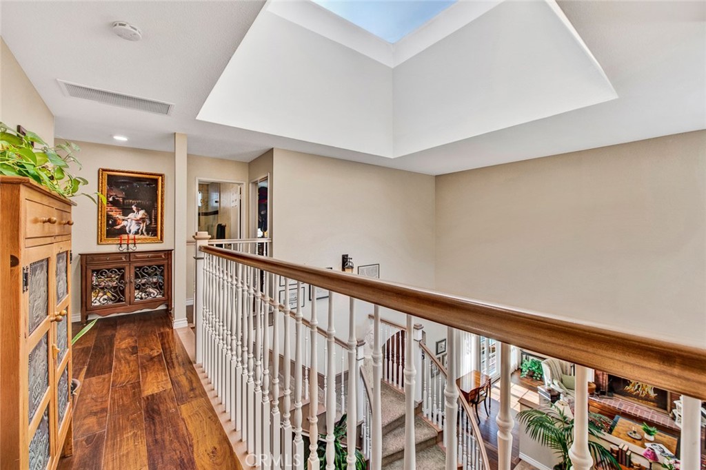 7214 East Wrangler Circle Orange, CA 92869 - Photo 42 of 69 a view of a hallway with wooden floor and staircase