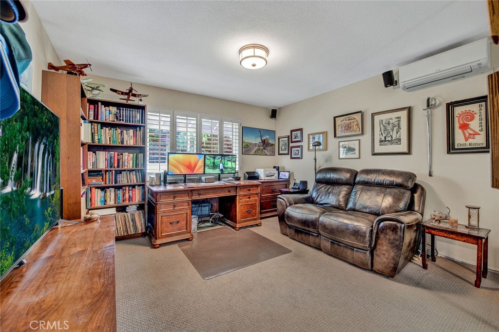 7214 East Wrangler Circle Orange, CA 92869 - Photo 44 of 69 a living room with furniture and a shelf