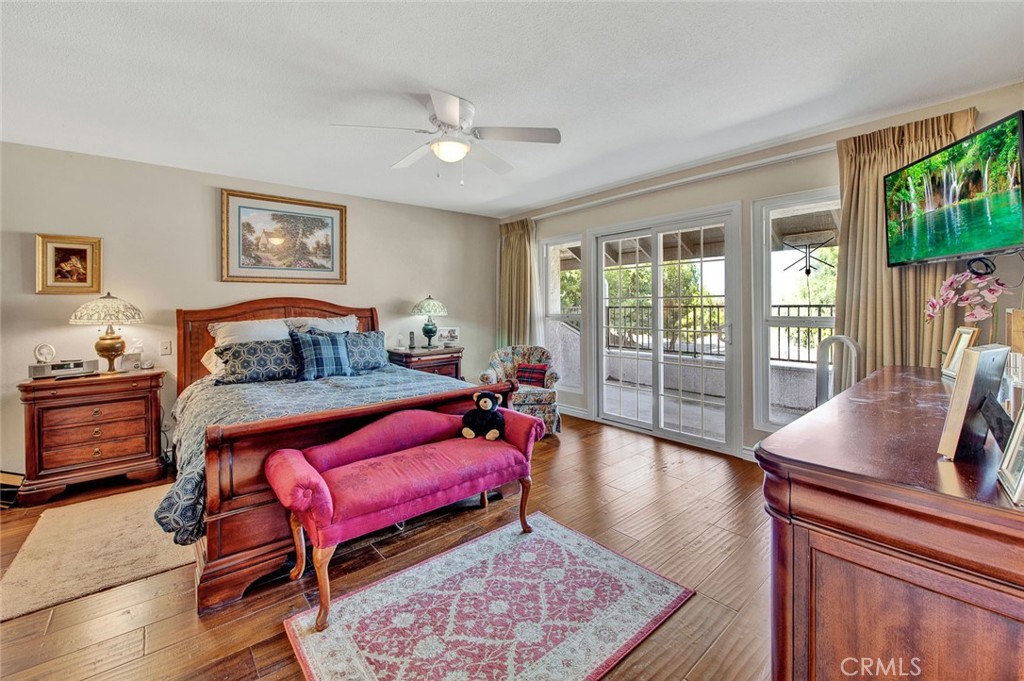 7214 East Wrangler Circle Orange, CA 92869 - Photo 55 of 69 a bedroom with a bed and wooden floor