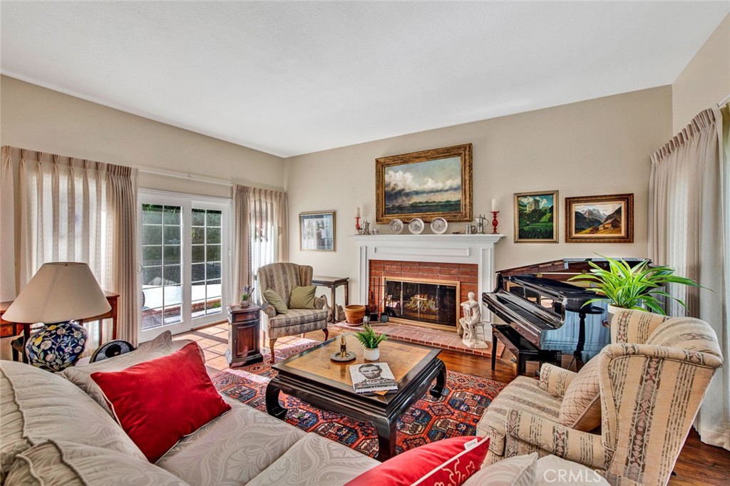 7214 East Wrangler Circle Orange, CA 92869 - Photo 9 of 69 a living room with furniture a flat screen tv and a fireplace