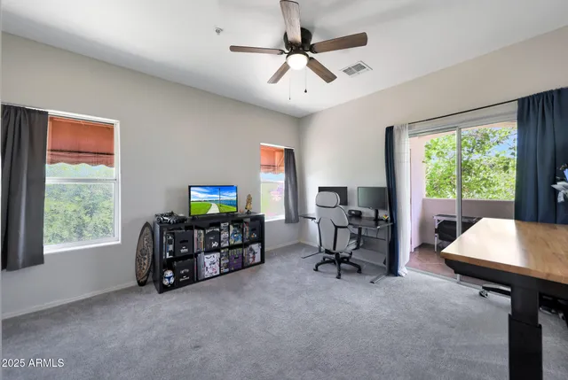 a view of a livingroom with furniture and flat screen tv