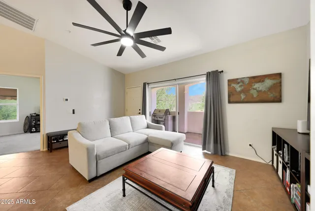a view of a living room and a kitchen with furniture a chandelier