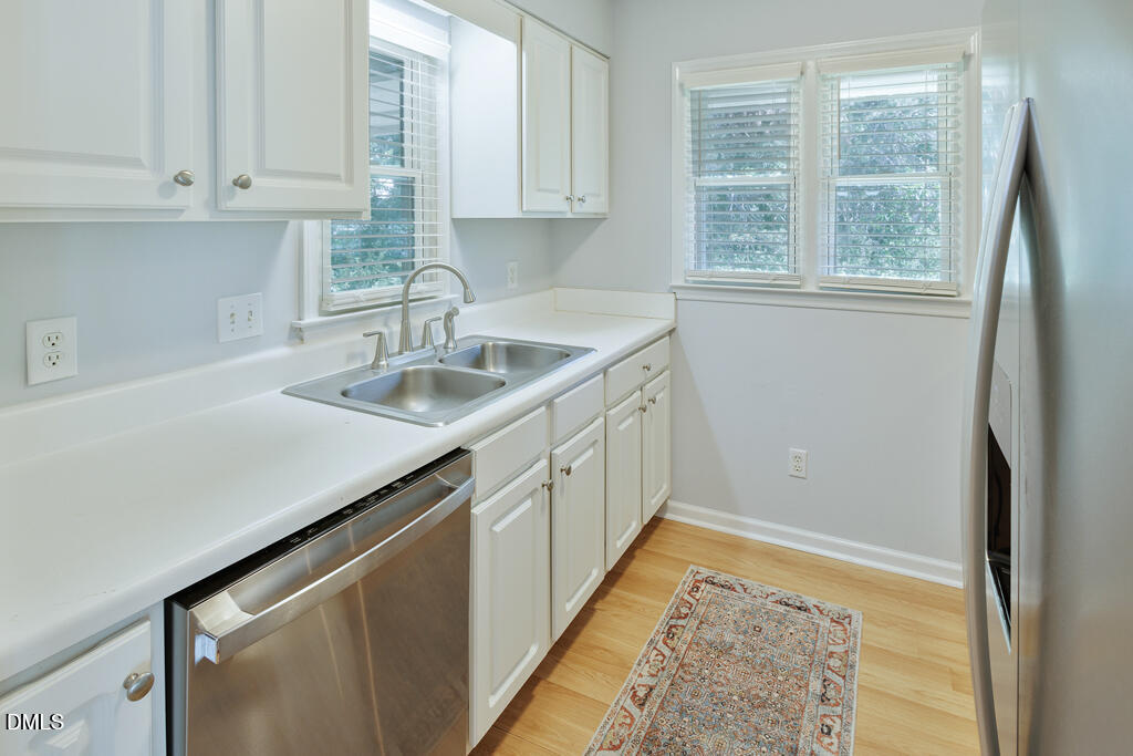 2831 Edridge Court, Unit 202 Raleigh, NC 27612 - Photo 11 of 33 a kitchen with granite countertop a sink and a window