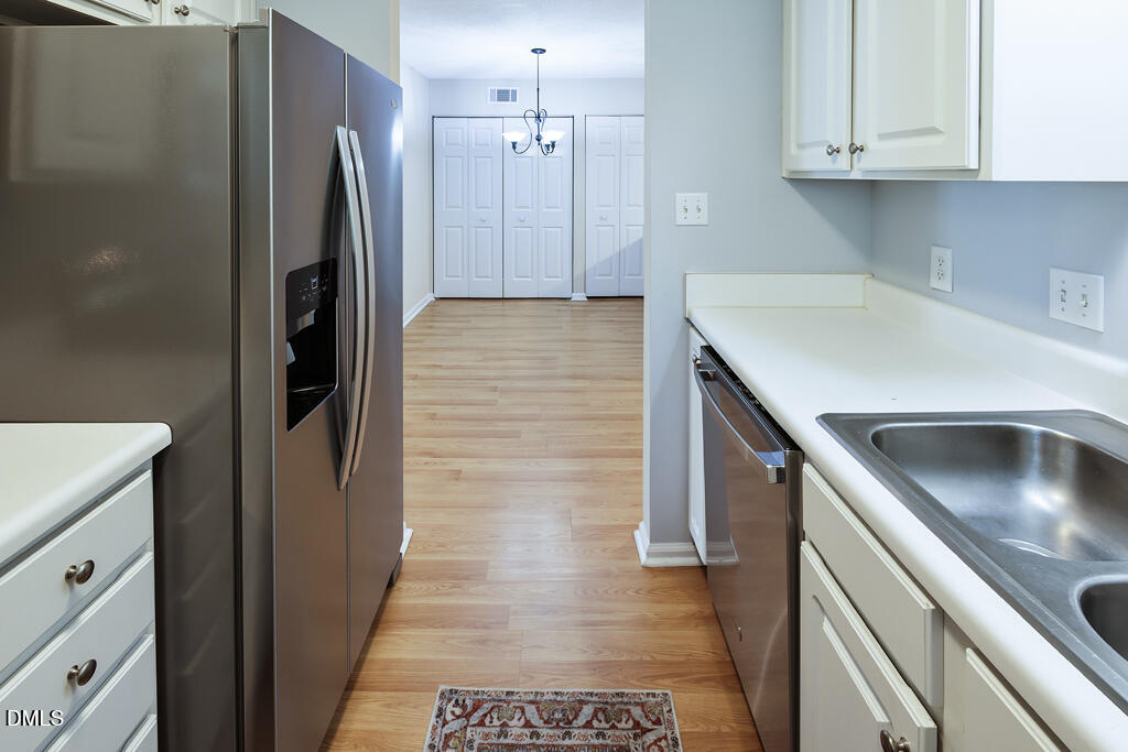 2831 Edridge Court, Unit 202 Raleigh, NC 27612 - Photo 12 of 33 a kitchen with stainless steel appliances granite countertop a refrigerator and a sink