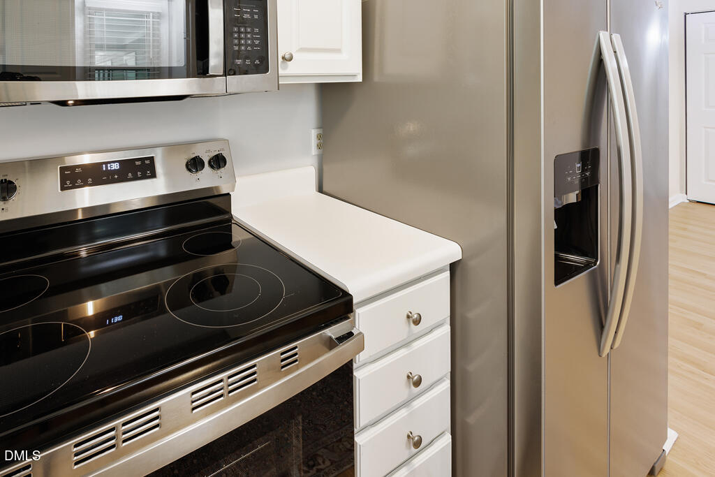 2831 Edridge Court, Unit 202 Raleigh, NC 27612 - Photo 13 of 33 a stove top oven sitting inside of a kitchen