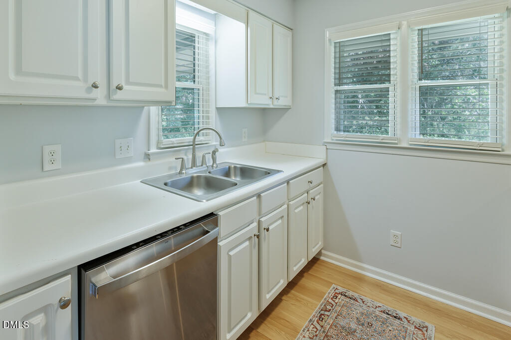 2831 Edridge Court, Unit 202 Raleigh, NC 27612 - Photo 15 of 33 a kitchen with a sink cabinets and window