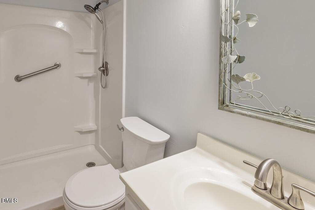 2831 Edridge Court, Unit 202 Raleigh, NC 27612 - Photo 19 of 33 a bathroom with a toilet sink and shower
