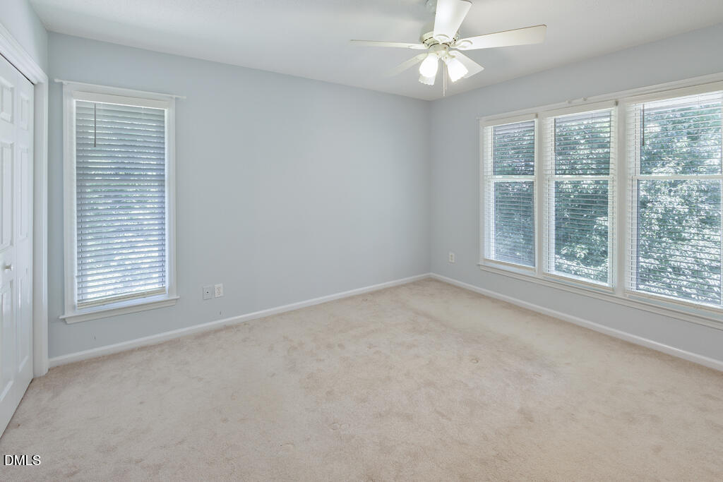 2831 Edridge Court, Unit 202 Raleigh, NC 27612 - Photo 22 of 33 an empty room with a window and a fan