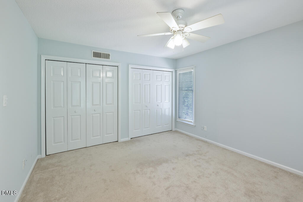 2831 Edridge Court, Unit 202 Raleigh, NC 27612 - Photo 24 of 33 a view of an empty room with a ceiling fan