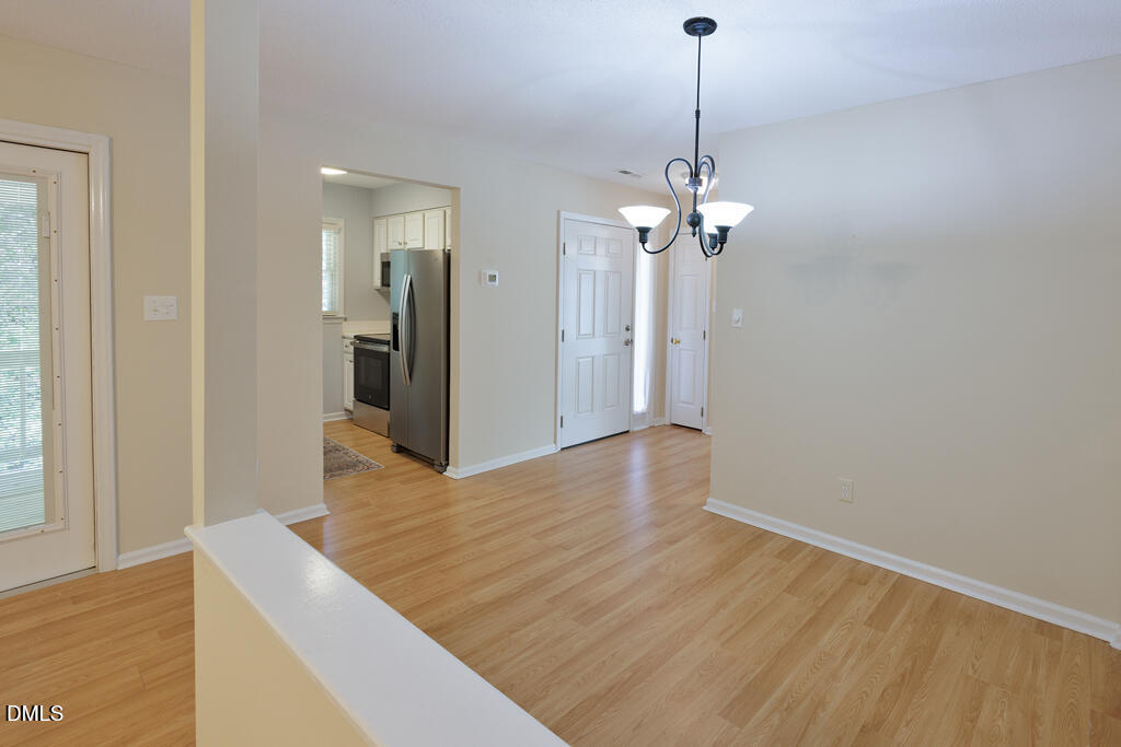 2831 Edridge Court, Unit 202 Raleigh, NC 27612 - Photo 6 of 33 a view of a chandelier in a room with a chandelier