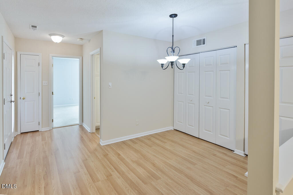 2831 Edridge Court, Unit 202 Raleigh, NC 27612 - Photo 7 of 33 a view of a room with wooden floor and ceiling fan