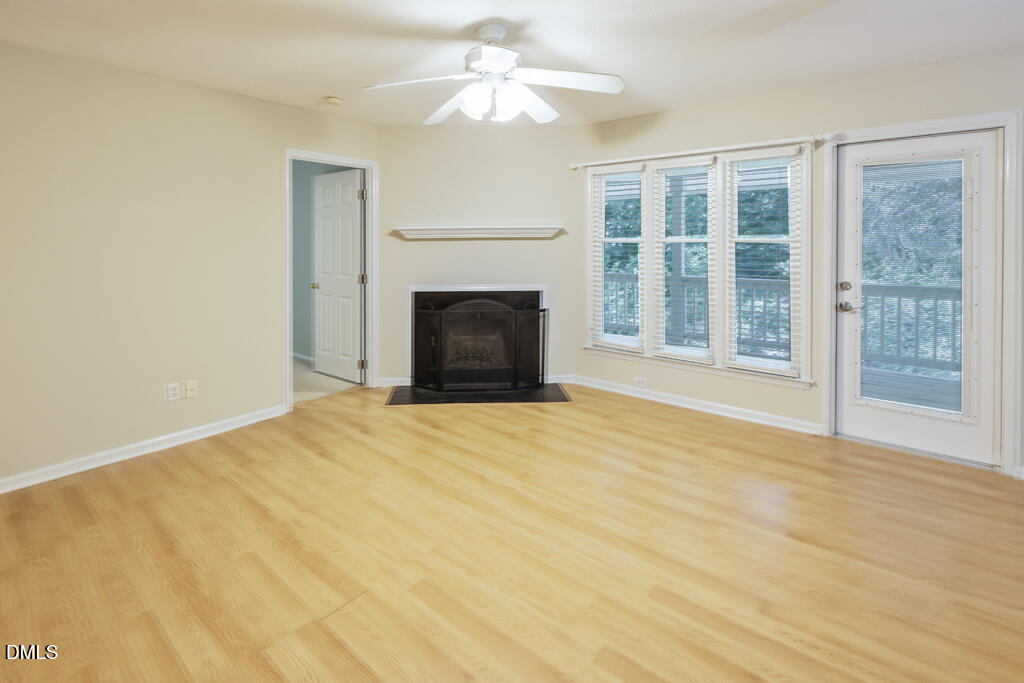 2831 Edridge Court, Unit 202 Raleigh, NC 27612 - Photo 10 of 33 a view of an empty room with a fireplace and a window