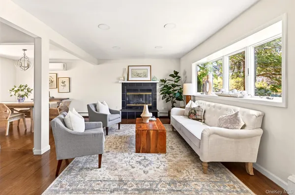 a living room with furniture fireplace and a rug