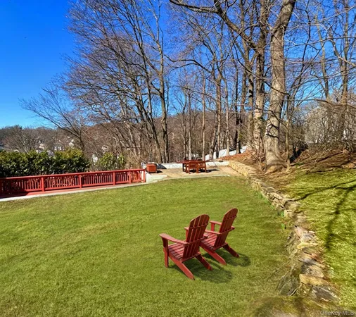 a kitchen with stainless steel appliances granite countertop a refrigerator a stove top oven a sink dishwasher and white cabinets with wooden floor