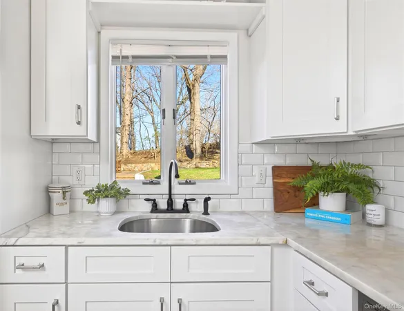 a bathroom with a sink mirror and toilet