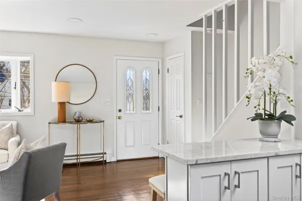 a room with furniture a mirror and a wooden floor