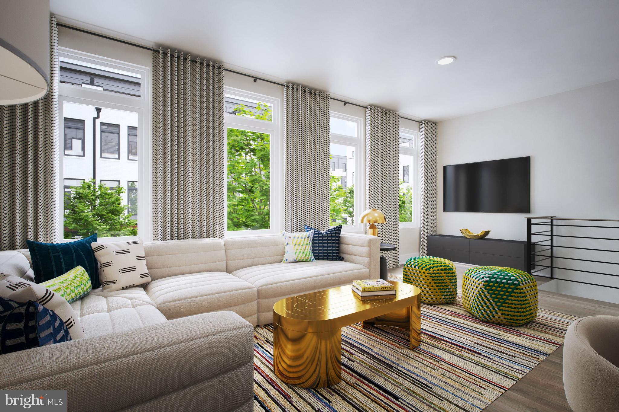 61 Lower Service Road Northwest, Unit POWELL 818 Washington, DC 20422 - Photo 9 of 12 a living room with furniture and a flat screen tv