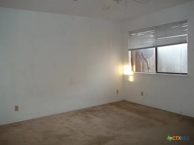 an empty room with a empty space and windows