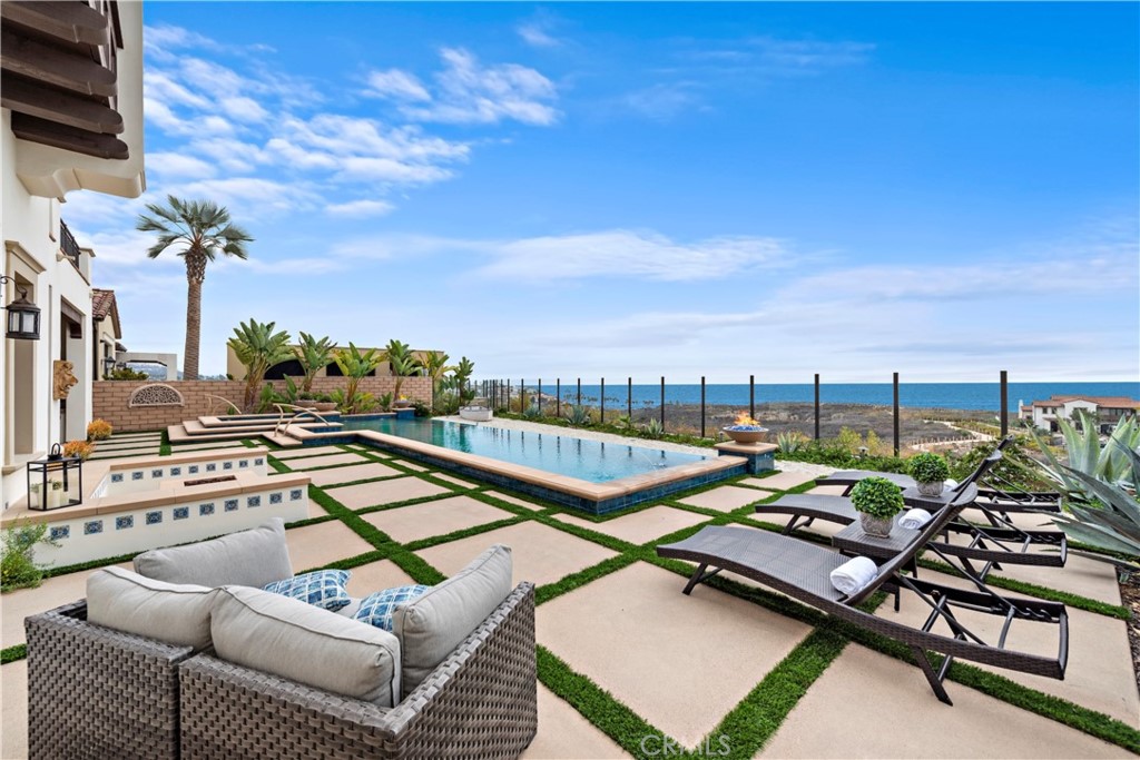 a view of a terrace with lawn chairs