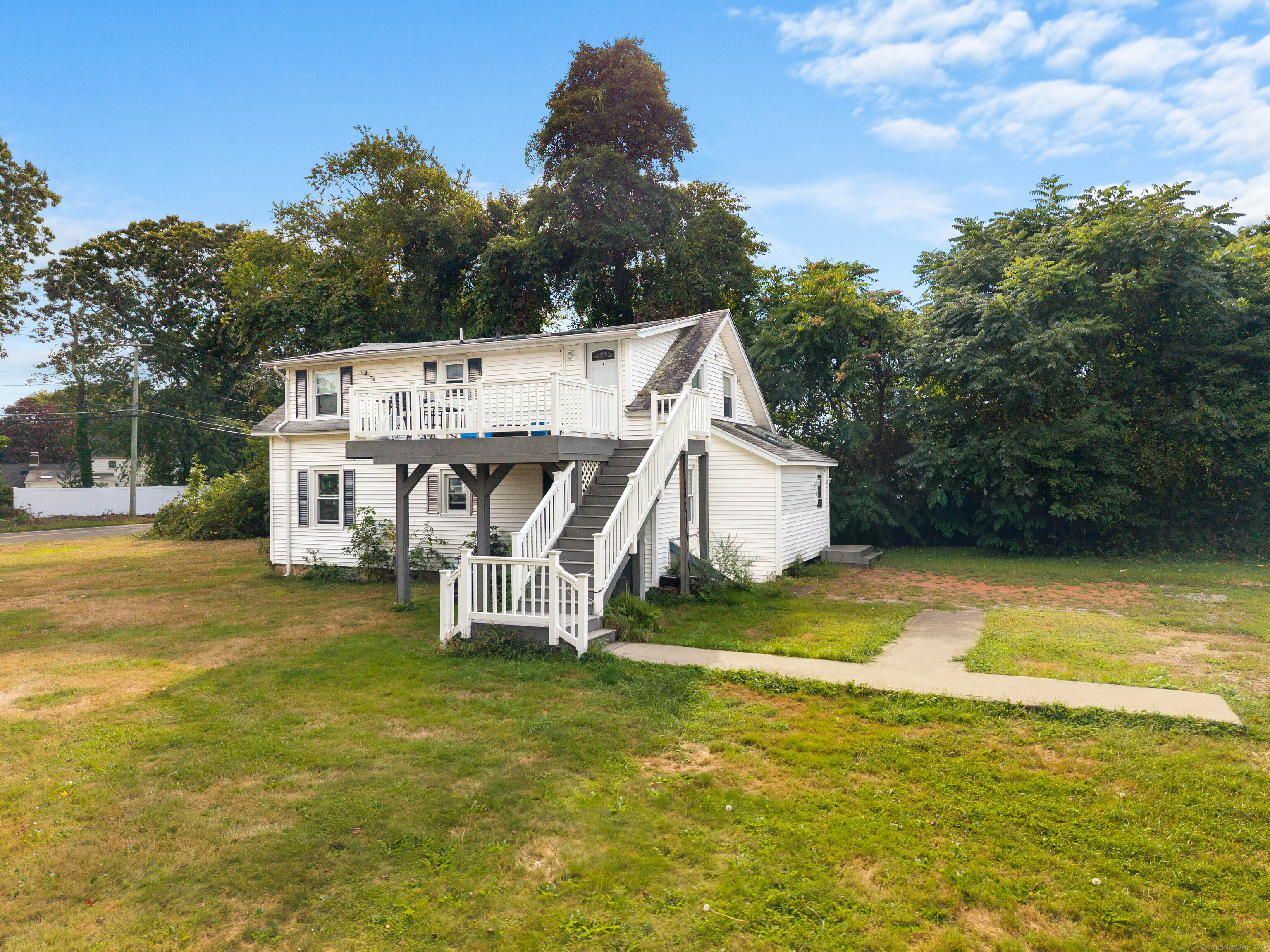224 Shore Road Old Lyme, CT 06371 - Photo 14 of 25 a view of a house with a yard and sitting area