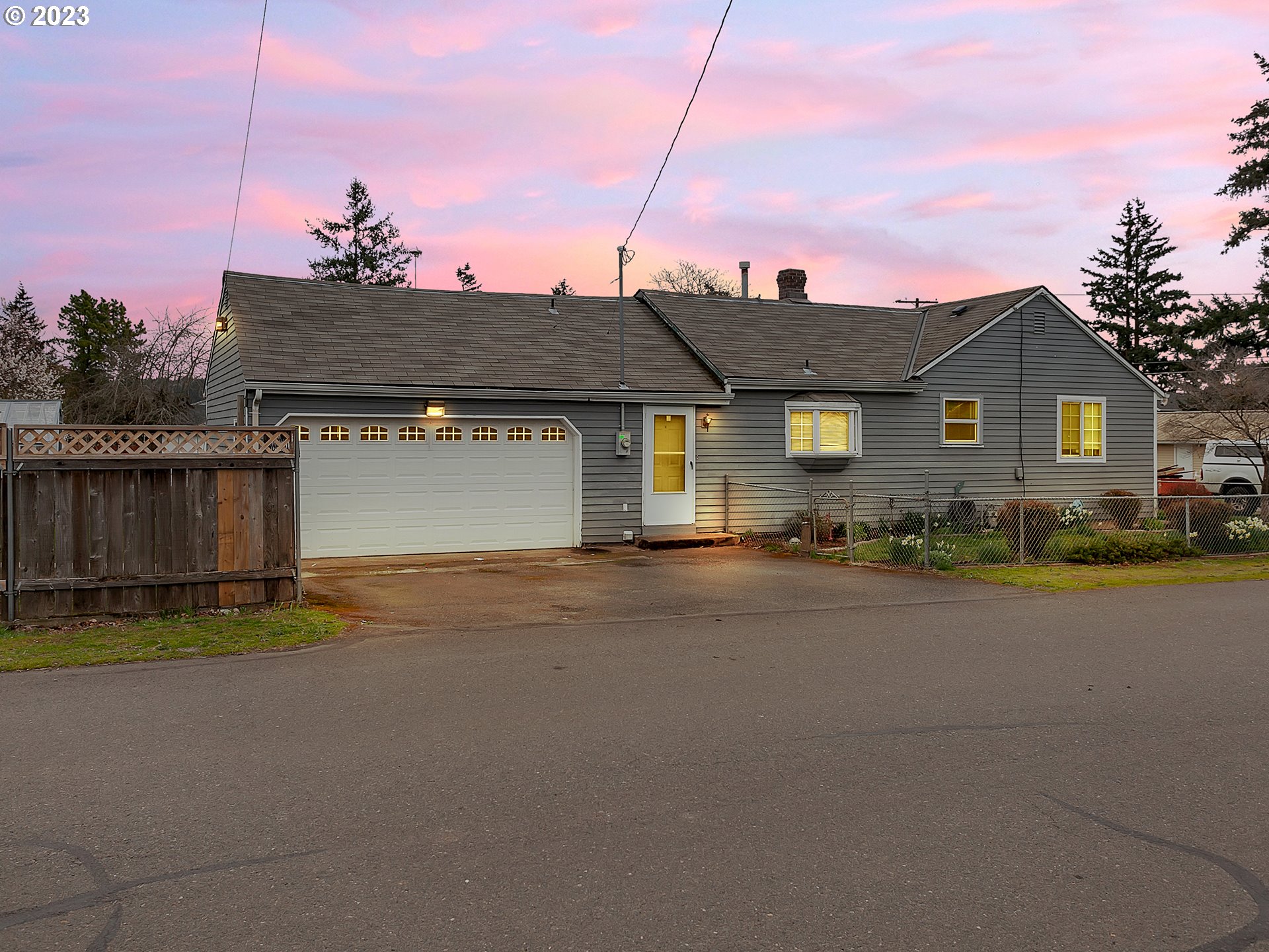 a front view of a house with a garden and yard
