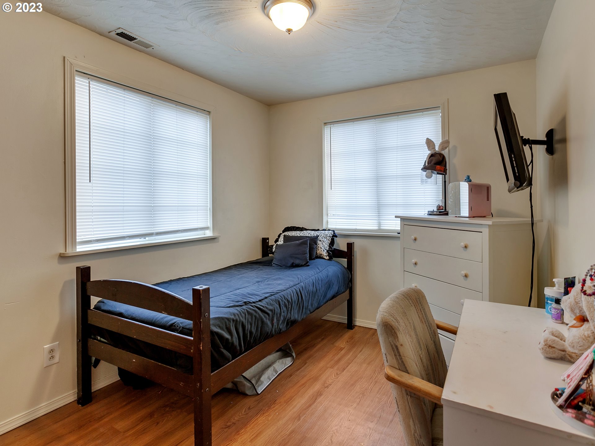 6701 Southeast Hazel Street Portland, OR 97206 - Photo 12 of 20 a bedroom with a bed and a dresser next to a window