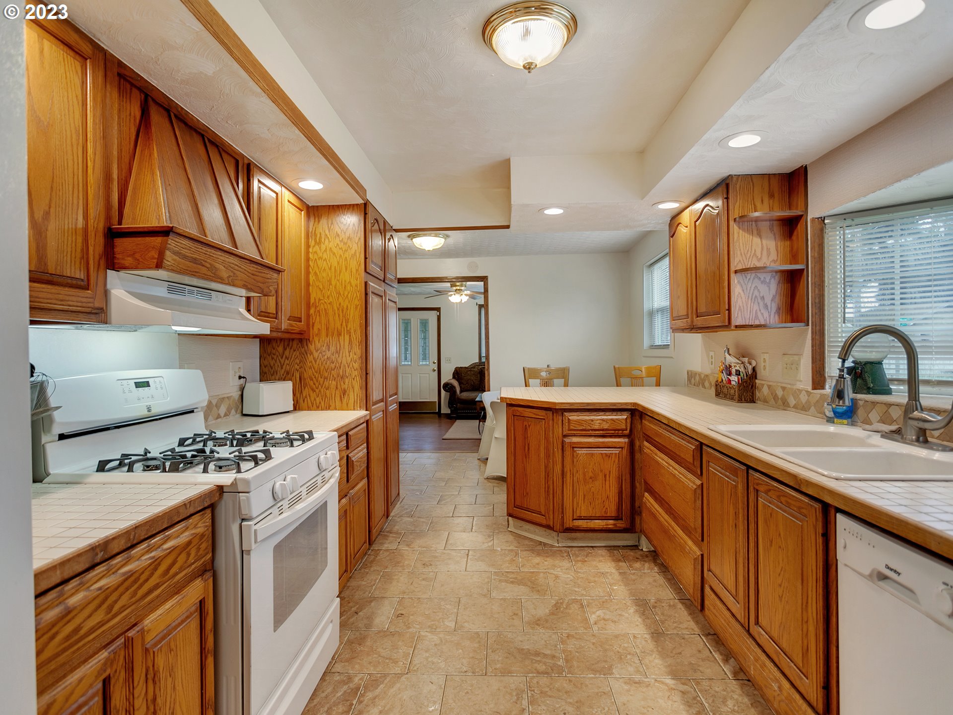 6701 Southeast Hazel Street Portland, OR 97206 - Photo 7 of 20 a kitchen with stainless steel appliances granite countertop a stove a sink dishwasher and cabinets
