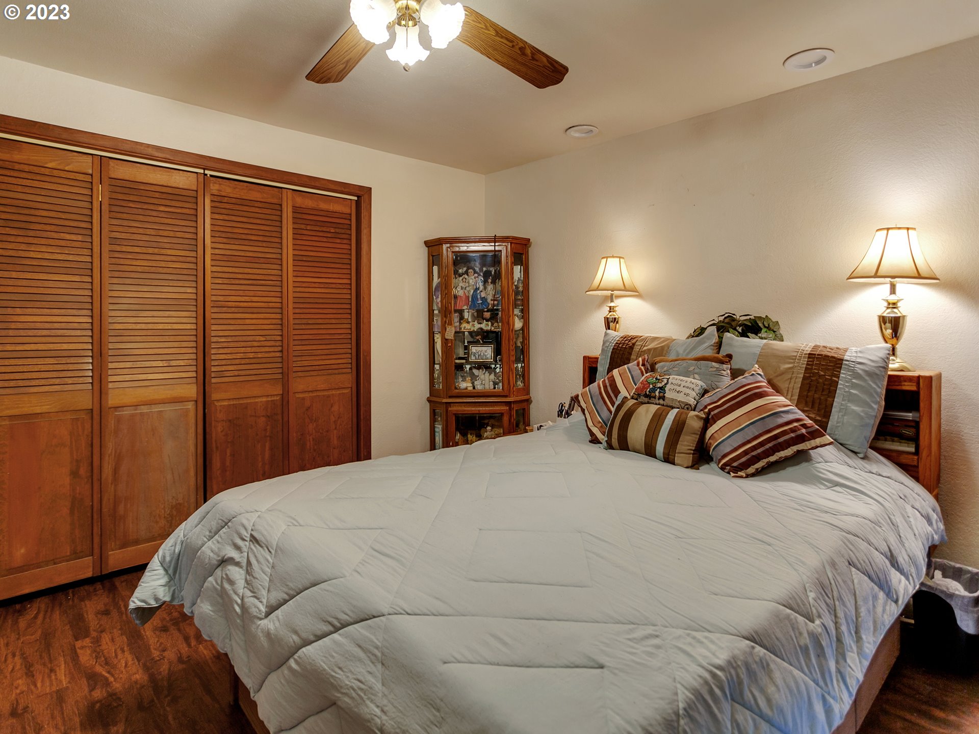 6701 Southeast Hazel Street Portland, OR 97206 - Photo 9 of 20 a large bedroom with a bed and a chandelier