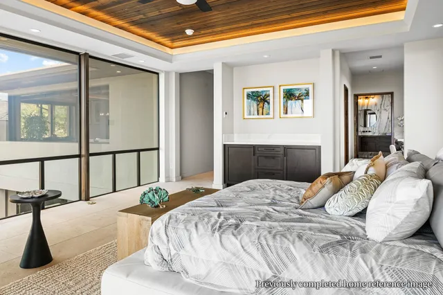 a bedroom with a bed and a large window