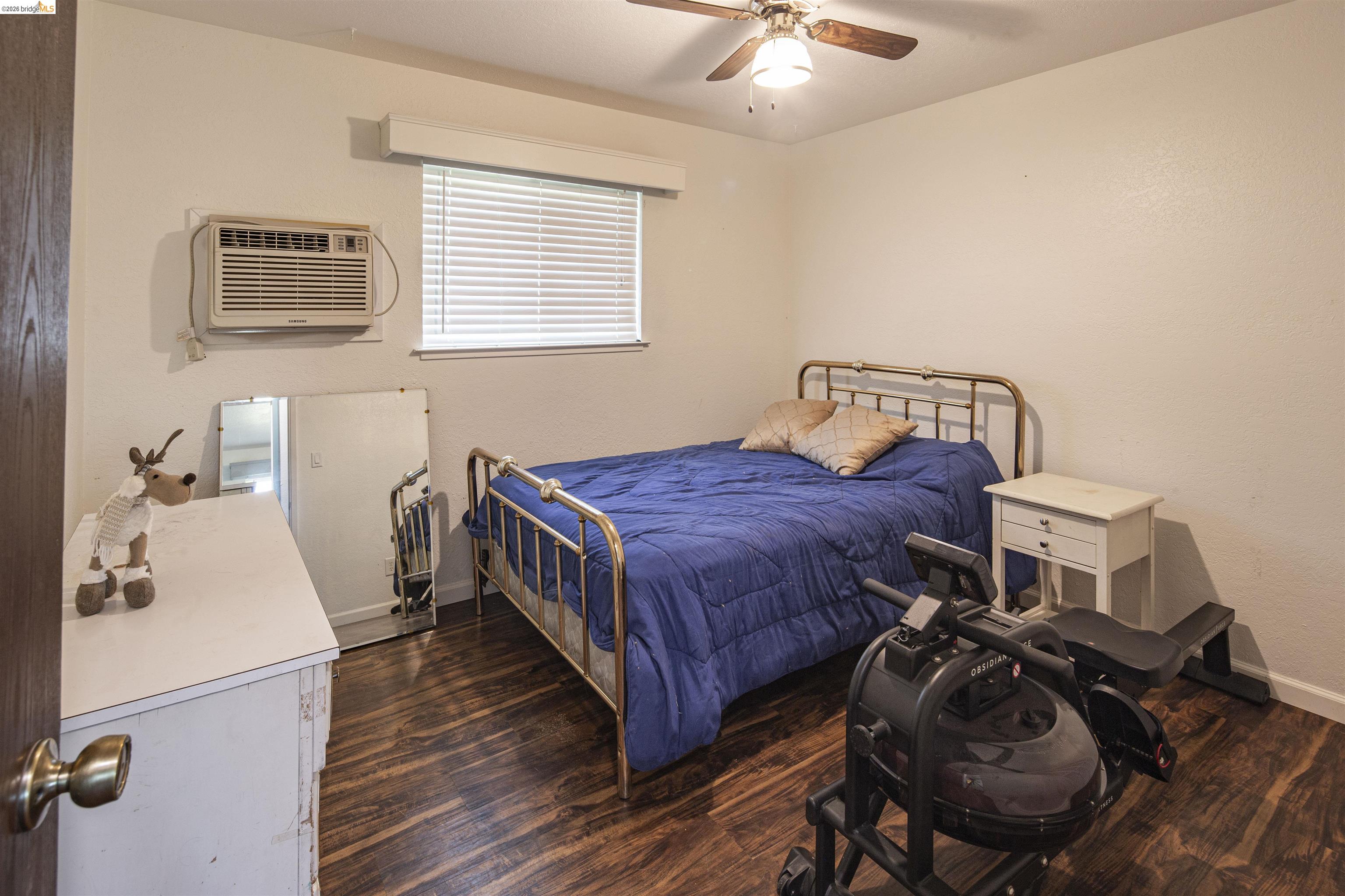10458 Southworth Road Valley Springs, CA 95252 - Photo 15 of 24 Bedroom featuring dark wood-type flooring and a ceiling fan