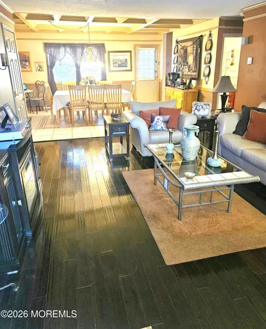 a living room with fireplace furniture and a table