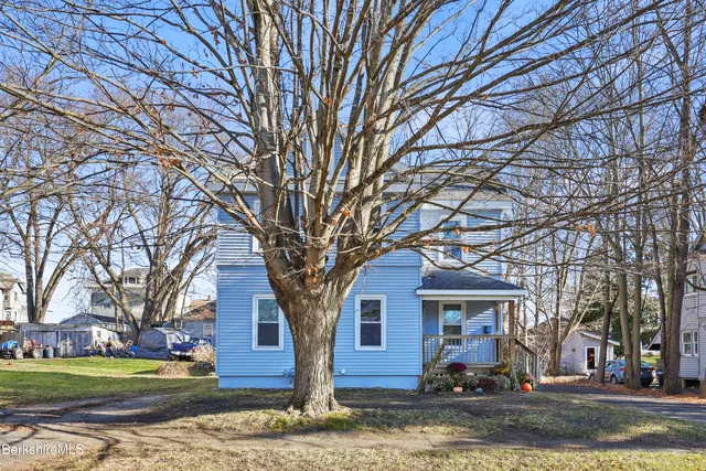 a view of a house with a snow on the road