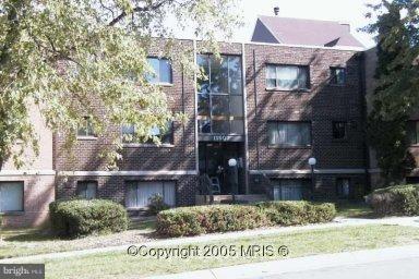 11507 Amherst Avenue, Unit 101 Silver Spring, MD 20902 - Photo 1 of 6 a front view of a house with a yard
