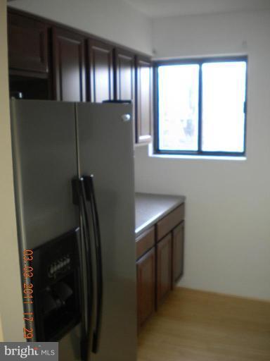 11507 Amherst Avenue, Unit 101 Silver Spring, MD 20902 - Photo 4 of 6 a kitchen with a refrigerator and window