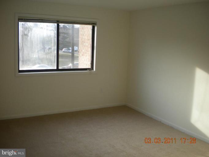 11507 Amherst Avenue, Unit 101 Silver Spring, MD 20902 - Photo 6 of 6 an empty room with a window