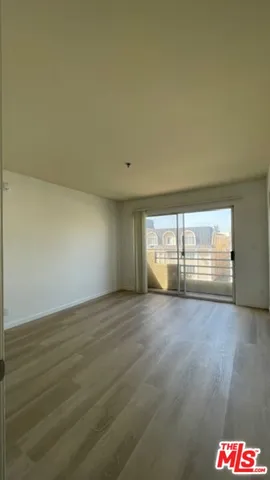 a view of an empty room and a window