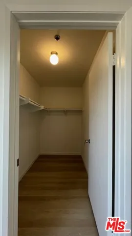 a view of room with stairs and a wooden floor