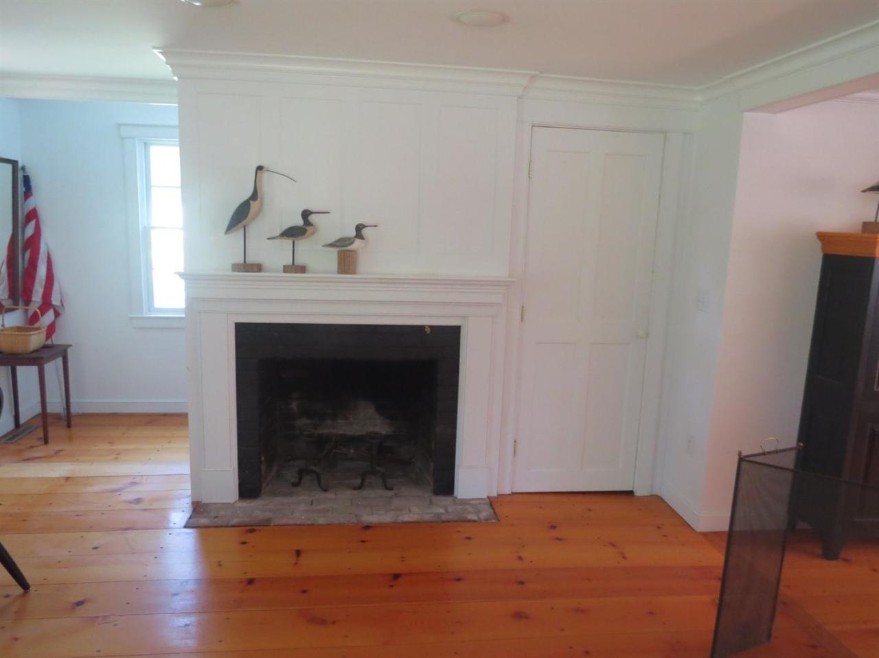 80 Middle Road Chatham, MA 02650 - Photo 8 of 21 a bedroom with a fireplace and a wooden floor