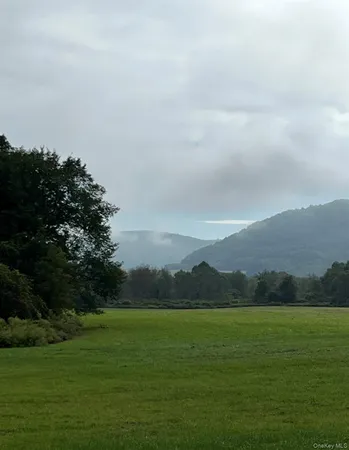a living room with furniture a flat screen tv and wooden floor