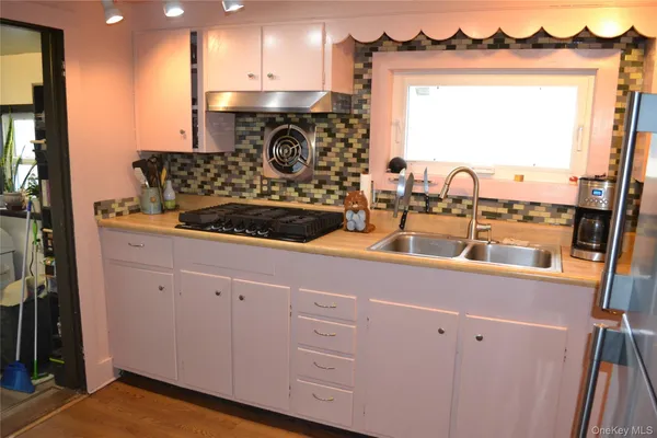 a kitchen with a refrigerator and a sink