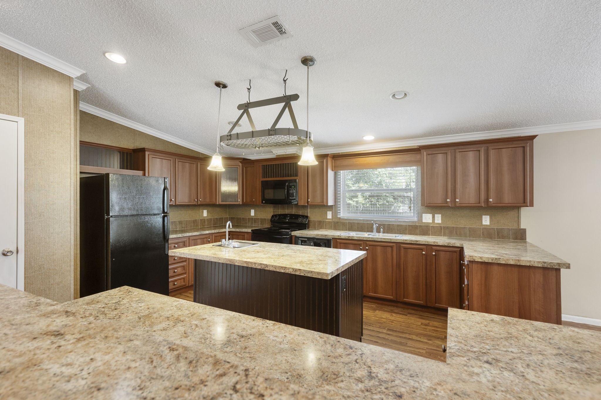 25330 Settlers Mill Road Magnolia, TX 77355 - Photo 12 of 21 a kitchen with stainless steel appliances granite countertop a sink a stove a refrigerator cabinets and a window
