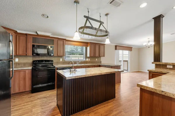 a kitchen with stainless steel appliances granite countertop a stove and a sink